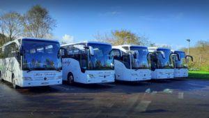 Hire Society luxury coach Glasgow hire five white coaches in car park