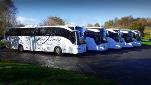 Hire Society coach hire Glasgow five white coaches in car park