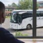 School bus hire Glasgow – pupil looks at a modern Hire Society coach outside his school in Glasgow 85x85