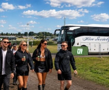 Festival coach hire Glasgow, group arriving by private coach at an outdoor music festival in Scotland
