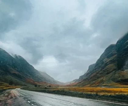 A road in the Scottish highlands with mountains in the background