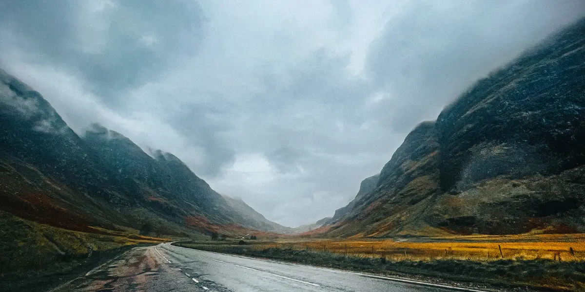 A road in the Scottish highlands with mountains in the background